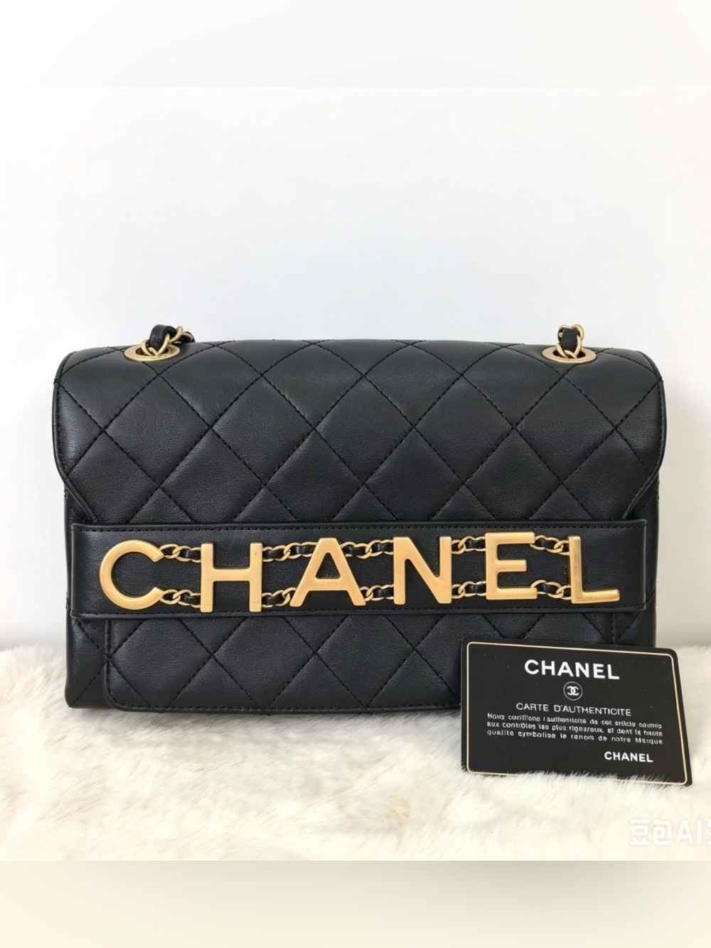 CHANEL Black Quilted Shoulder Bag with Gold Lettering